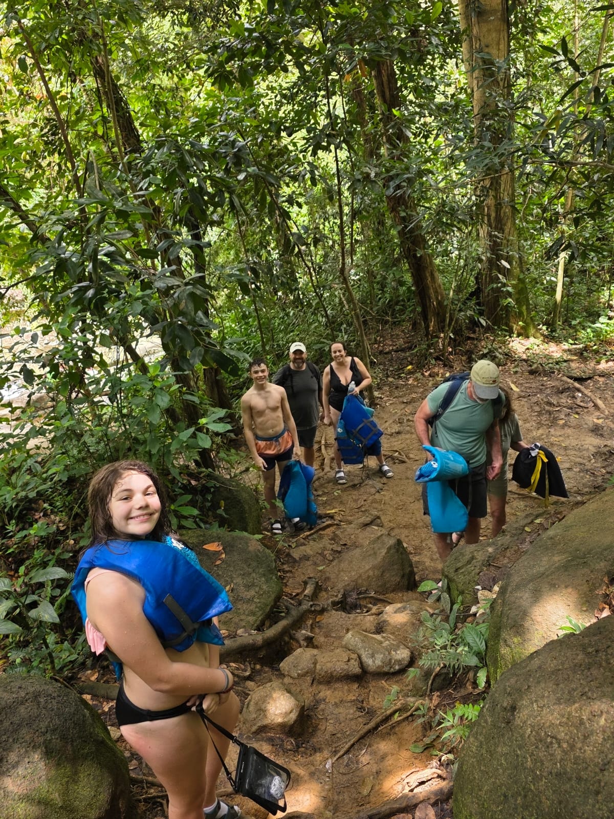 Tour group hiking through the lush jungle trail — an adventure you can't get on your own